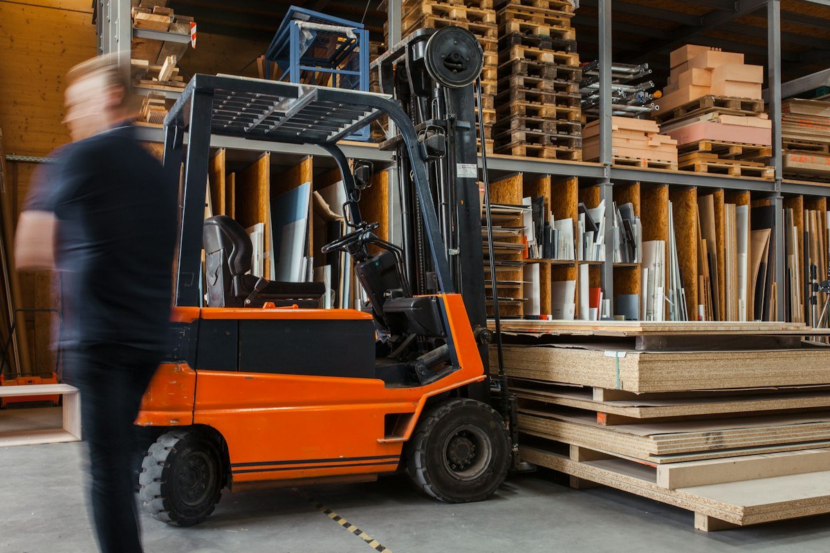 Forklift and timber inventory in a construction materials warehouse