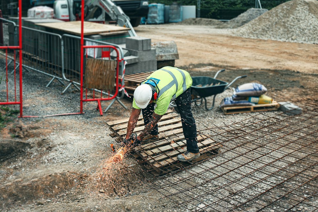 Construction worker inspecting materials at a building site