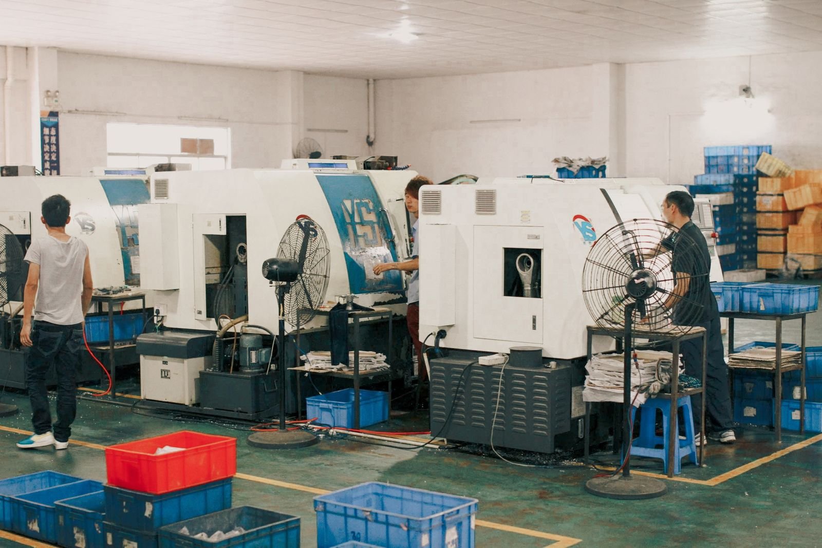 Manufacturing workers operating machinery in a production facility