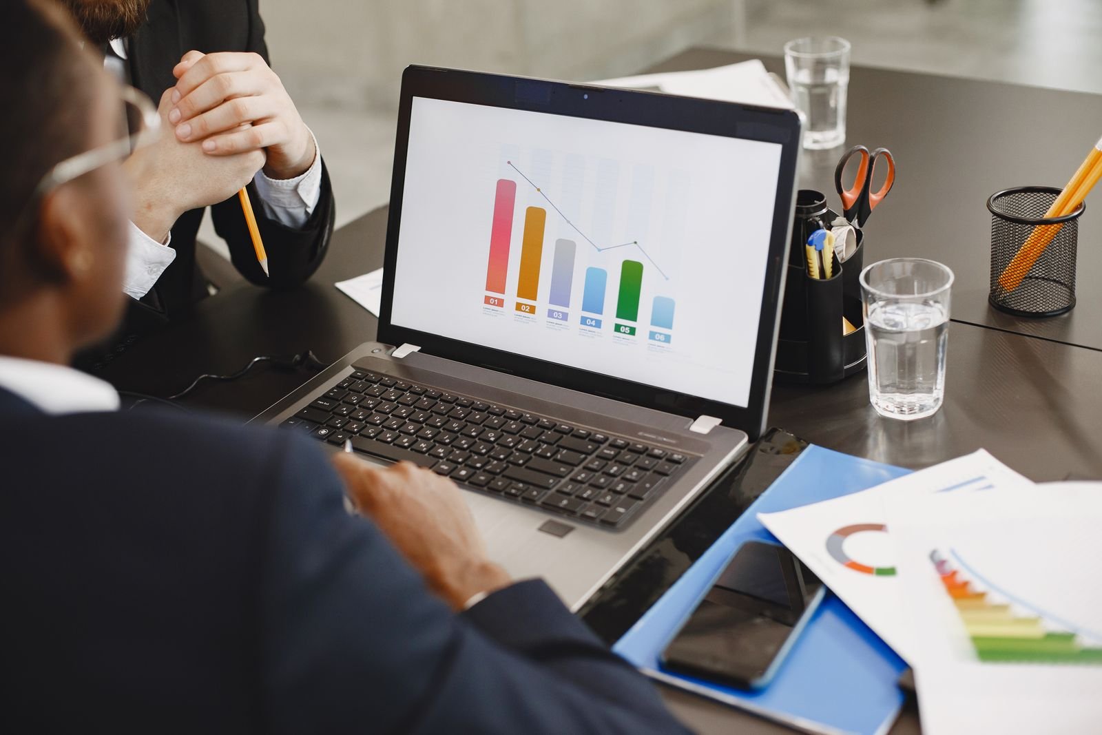 Professionals reviewing business analytics during an Odoo ERP and Power BI integration project